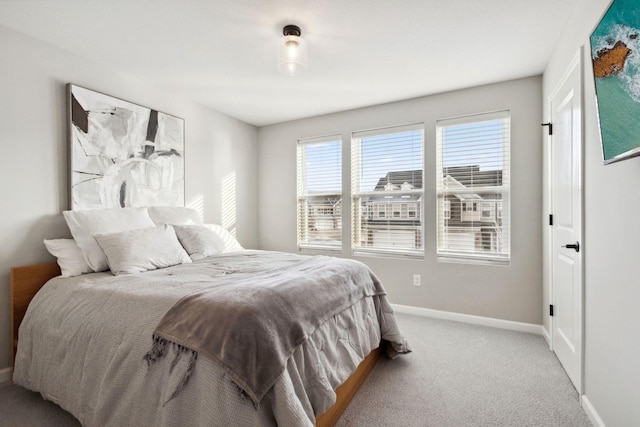 bedroom featuring carpet flooring and baseboards