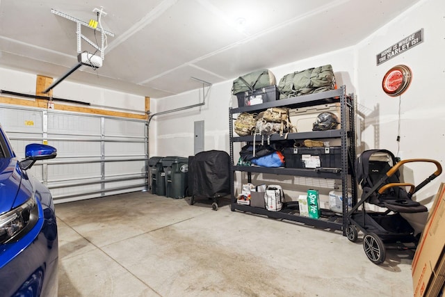 garage with electric panel and a garage door opener