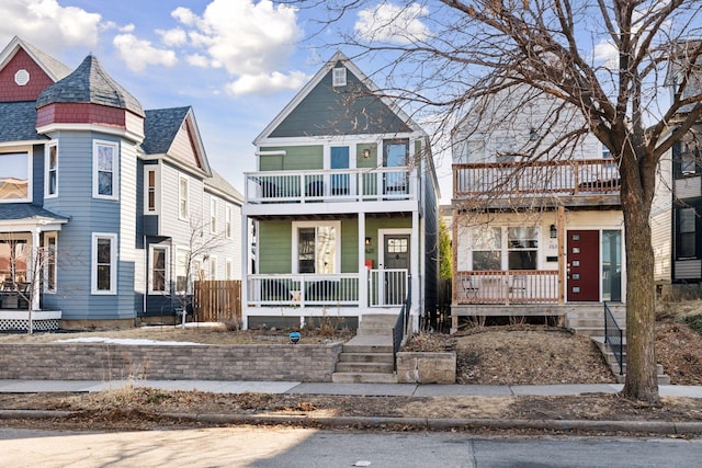 victorian home featuring a balcony and covered porch