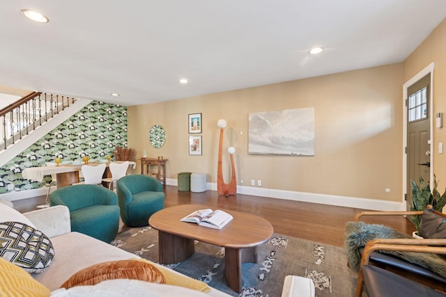 living room featuring stairs, recessed lighting, wood finished floors, and baseboards