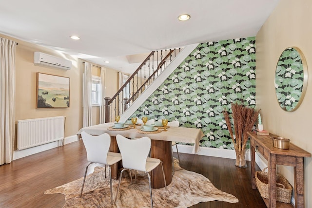 dining room featuring a wall mounted air conditioner, recessed lighting, wood finished floors, and radiator heating unit