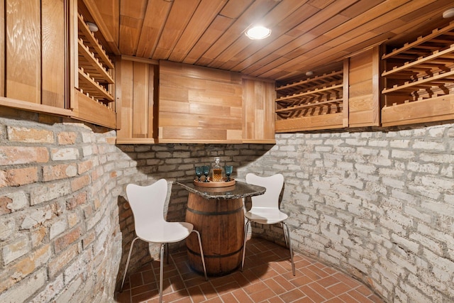 wine cellar with brick floor and wooden ceiling