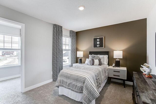 carpeted bedroom featuring baseboards