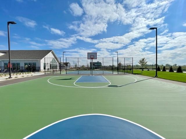 view of basketball court featuring community basketball court and fence