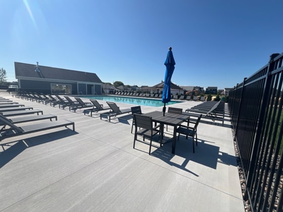 view of patio featuring a community pool and fence