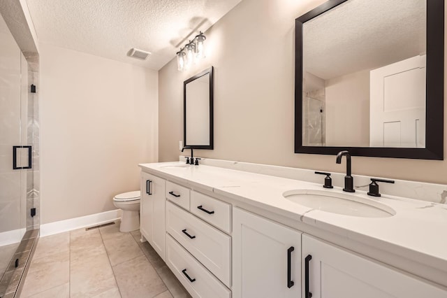 bathroom with a sink, visible vents, toilet, and a shower stall