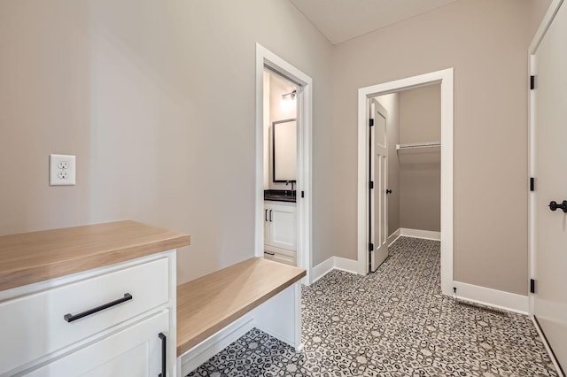 mudroom with light floors and baseboards