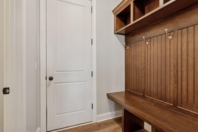 mudroom featuring wood finished floors and baseboards