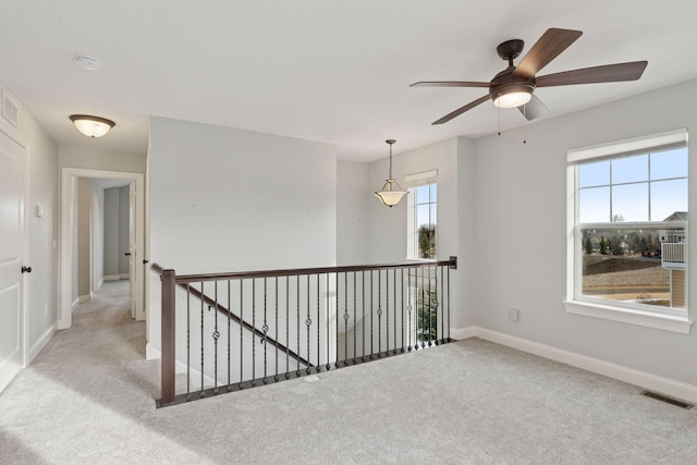 unfurnished room featuring baseboards, visible vents, and carpet floors