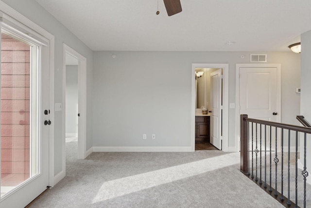 interior space with baseboards, visible vents, and ceiling fan