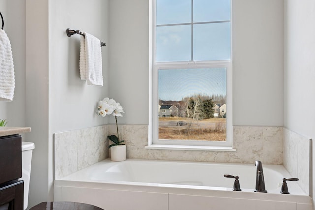 full bath featuring plenty of natural light and a garden tub