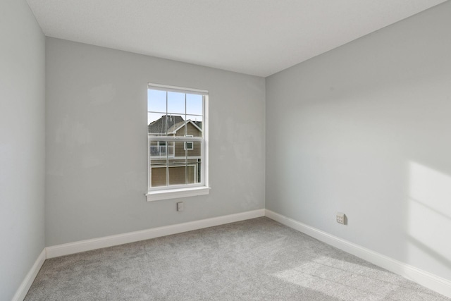 carpeted spare room with baseboards