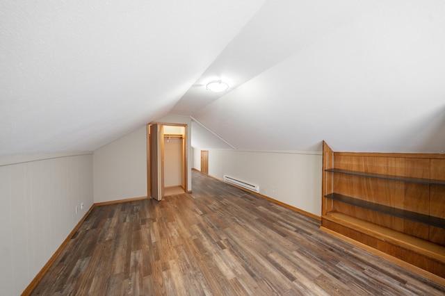 bonus room featuring a baseboard radiator, baseboards, wood finished floors, and vaulted ceiling