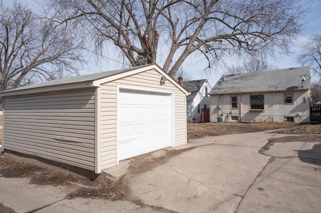 detached garage with concrete driveway