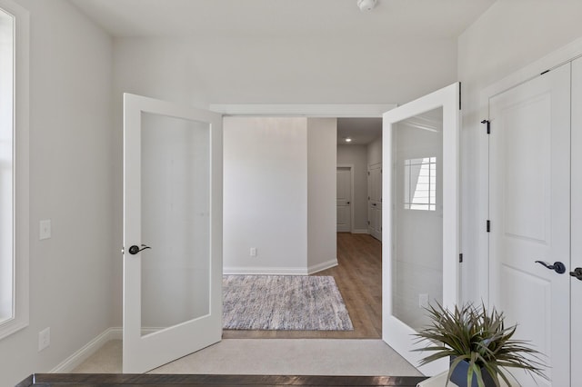 interior space featuring baseboards and wood finished floors