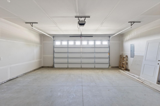 garage featuring electric panel and a garage door opener