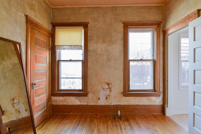 empty room with light wood-type flooring and baseboards