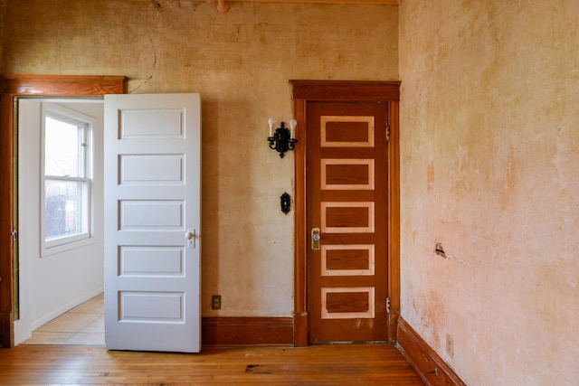 interior space with baseboards and light wood-style floors