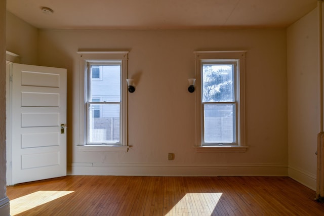 foyer entrance featuring baseboards and hardwood / wood-style flooring