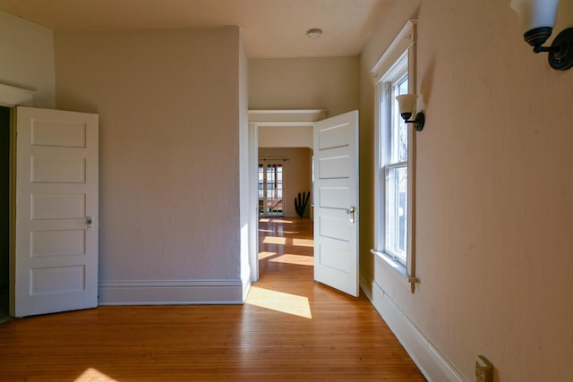 unfurnished room with wood finished floors and baseboards