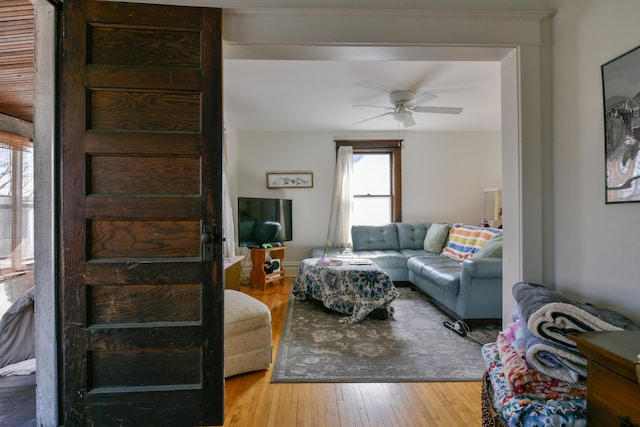 living room with hardwood / wood-style floors and a ceiling fan