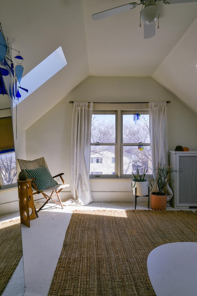 additional living space featuring vaulted ceiling with skylight, carpet flooring, and ceiling fan