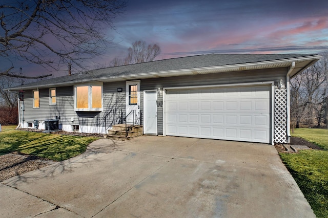 ranch-style home with roof with shingles, central AC unit, concrete driveway, and an attached garage