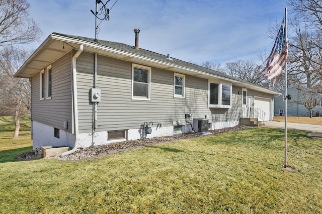 rear view of property with central AC unit, concrete driveway, a lawn, and a garage