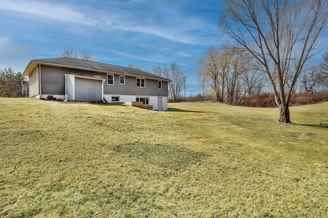 back of property featuring a lawn