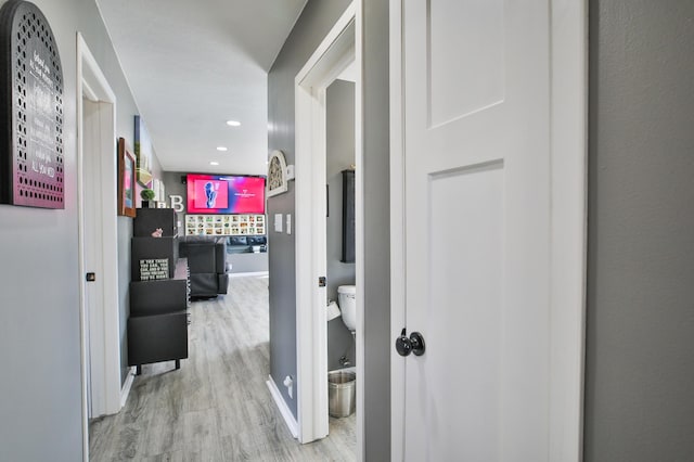 hall featuring recessed lighting, wood finished floors, and baseboards