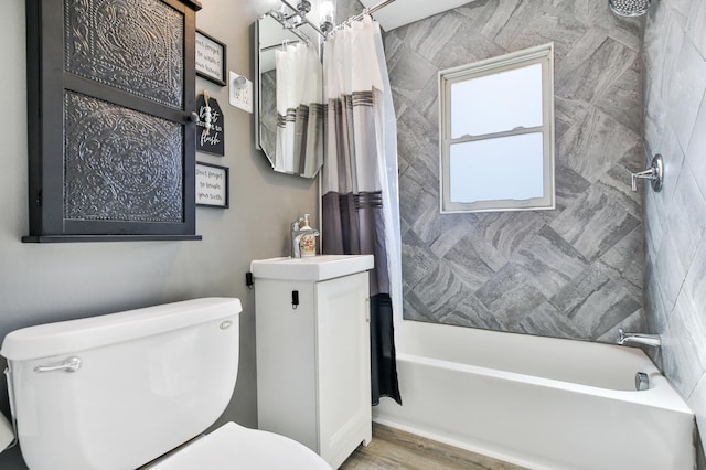 bathroom featuring shower / bath combination with curtain, toilet, wood finished floors, and a sink