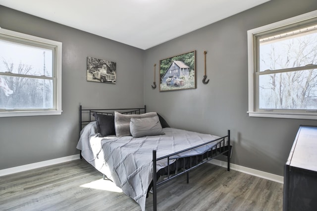 bedroom featuring baseboards and wood finished floors