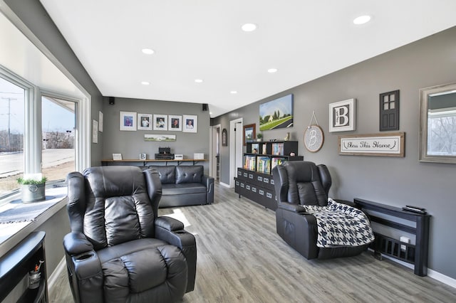 living area with plenty of natural light, recessed lighting, and light wood-type flooring