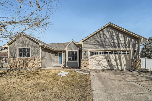 single story home featuring brick siding, an attached garage, concrete driveway, and fence