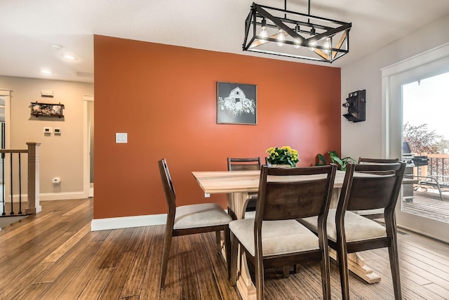 dining area with wood finished floors and baseboards