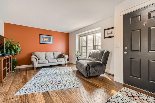 living room featuring baseboards and wood finished floors