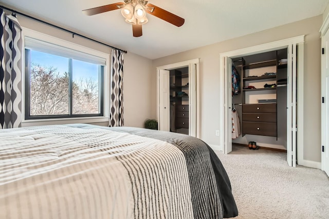 bedroom featuring light colored carpet, baseboards, and ceiling fan