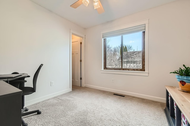 office space featuring visible vents, a ceiling fan, baseboards, and carpet floors