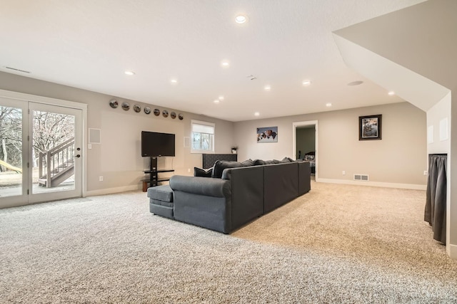 living area featuring recessed lighting, light colored carpet, visible vents, and baseboards