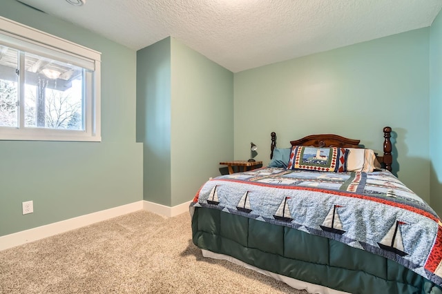 carpeted bedroom featuring baseboards and a textured ceiling