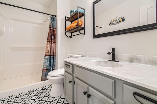 bathroom with vanity, a shower stall, and toilet