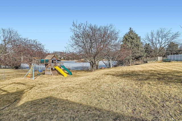 view of yard featuring fence and a playground