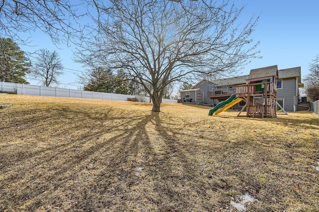 view of yard with a playground and fence