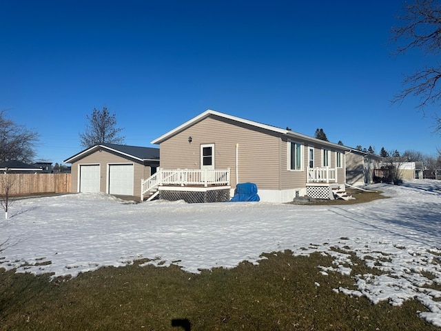 exterior space with an outdoor structure, fence, and a detached garage