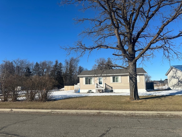 view of front of property with a front yard and fence