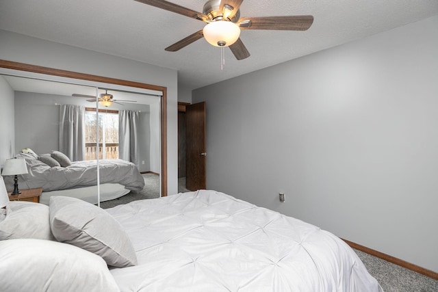 carpeted bedroom with a closet, ceiling fan, a textured ceiling, and baseboards