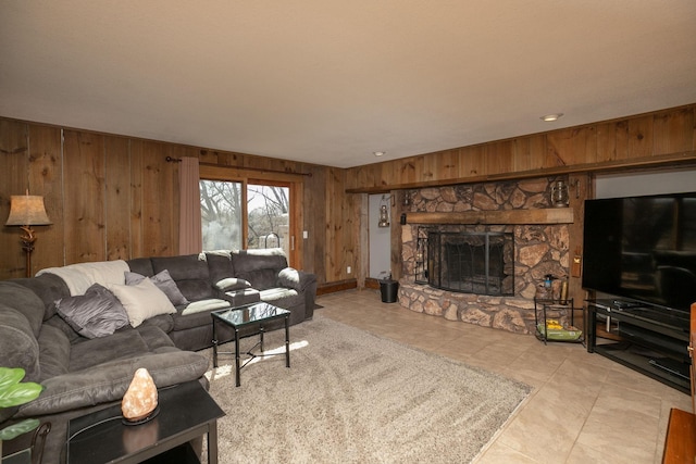 living room with wooden walls, a fireplace, and tile patterned flooring