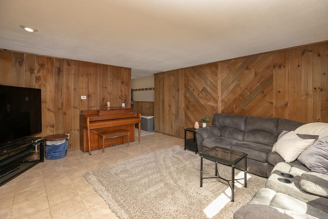 living area with light tile patterned flooring and wood walls