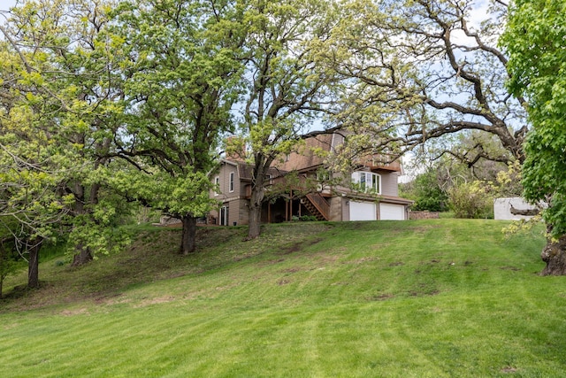809 60th Ave SW, Rochester, MN 55902 - view of grassy yard featuring stairway and an attached garage