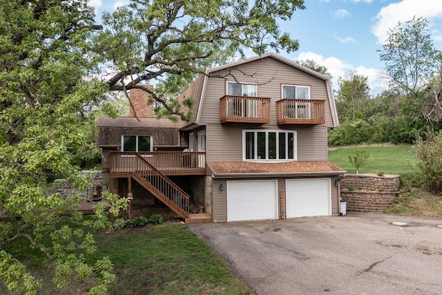 809 60th Ave SW, Rochester, MN 55902 - view of front of home featuring a balcony, a gambrel roof, stairs, and asphalt driveway